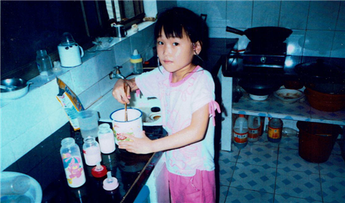 Elise Lutz as a child making bottles for babies in the special needs orphanage 